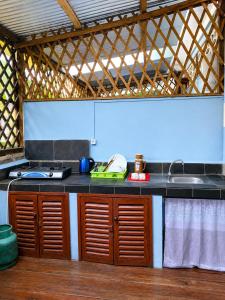 a kitchen with a sink and a counter top at Studio Ylang - Vue mer & détente à Nosy Be in Nosy Be