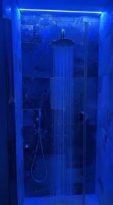 a bathroom with a shower with blue lights at Pietra Museum Suites Sirolo in Sirolo