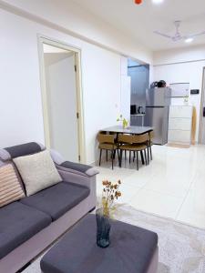a living room with a couch and a table at Minique stay - spacious 3BR in Furena