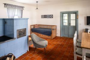 a small room with a bed and a chair in it at Statek u Benešů in Ponědraž