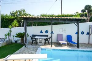 a patio with a table and chairs next to a swimming pool at Efi Pool & View Alepochori i in Kato Alepochori