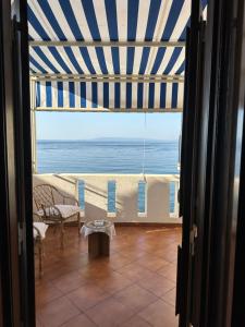 a room with a view of the ocean from a balcony at Marea Chianalea in Scilla