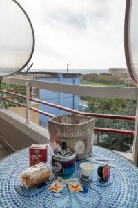 a table with a basket and food on a balcony at B&B Civico 15 in Nettuno