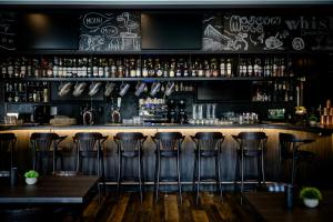 a bar with bar stools in a restaurant at Hotel Kiel-Schwedenkai in Kiel