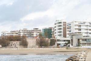 a view of a beach with buildings in the background at B&B Civico 15 in Nettuno