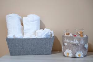 two baskets filled with towels on a table at B&B Civico 15 in Nettuno +96 photos