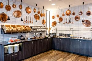 a kitchen with wooden counters and pots and pans at Hotel Kiel-Schwedenkai in Kiel