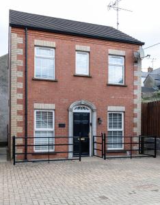 a red brick house with a black door at 18 Garden Mews in Cookstown
