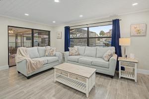 a living room with two couches and a table at Moonlight Bay in Port Richey
