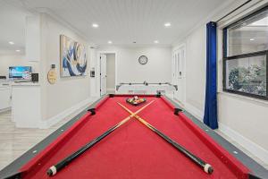 a pool table in a room with four cuesticks at Moonlight Bay in Port Richey