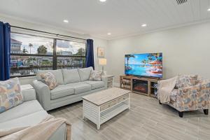 a living room with a couch and a tv at Moonlight Bay in Port Richey