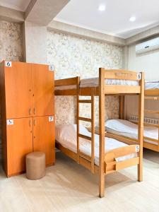a room with two bunk beds and a cabinet at Suli Hostel in Tbilisi City