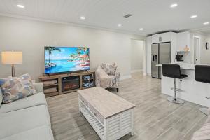 a living room with a couch and a tv at Moonlight Bay in Port Richey +54 photos