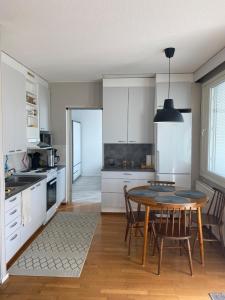 a kitchen with a table and chairs in a room at Kasakankuja Kajaani in Kajaani