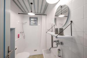 a white bathroom with a sink and a mirror at Statek u Benešů in Ponědraž +26 photos