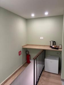 a kitchen with a counter and a shelf at Scilla Central Rooms in Scilla