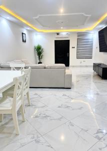 a living room with a couch and a table at CB Apartment in Santeo