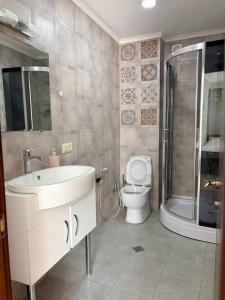 a bathroom with a toilet and a sink and a shower at Suli Hostel in Tbilisi City +55 photos