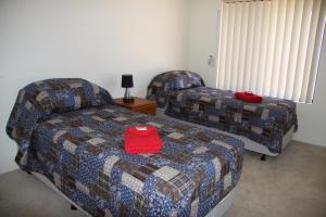 a bedroom with a bed and a couch and a chair at Byford House on the Scarp in Armadale