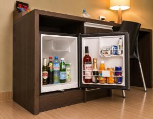 a small refrigerator filled with drinks and alcohol at Rado Hotel - Santa María in Trujillo