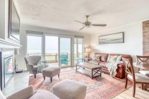 a living room with a couch and a fireplace at Waveside Hideaway, Unit 11 in Neskowin
