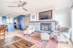 a living room with a fireplace and a table and chairs at Waveside Hideaway, Unit 11 in Neskowin