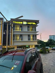 a car parked in front of a hotel at Tdoze Hotel At Piccadilly Ipoh in Ipoh