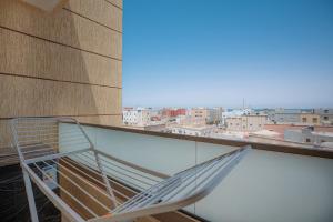 a metal staircase on a building with a view of a city at Sahoria Stay in Dakhla