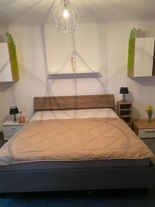 a bedroom with a large bed with two night stands at Alpenresidenz Viktoria in Türnitz