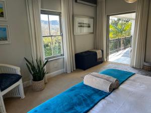 a bedroom with a large bed and a large window at Luxury Five Bed Villa in the Heart of Franschhoek in Franschhoek +89 photos