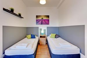 Posteľ alebo postele v izbe v ubytovaní Nice Rooms - Pokoje Gościnne