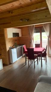 a kitchen and dining room with a table and chairs at Vila Paradiso in Slatina Varoš +5 photos