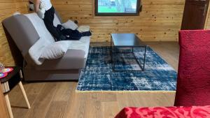 a living room with a couch and a coffee table at Vila Paradiso in Slatina Varoš