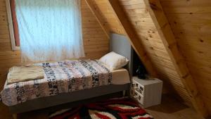 a bedroom with a bed and a window at Vila Paradiso in Slatina Varoš