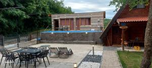 a patio with a table and chairs and a pool at Vila Paradiso in Slatina Varoš