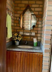a bathroom with a sink in a brick wall at Estação Serrana in Pedro II