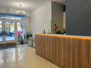 a man sitting at a counter in a restaurant at Alpino Hotel in Buenos Aires