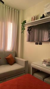 a room with a chair and a table and a window at Zahra Elegant Studio in Sīdī ‘Abd ar Raḩmān