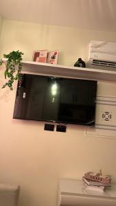 a flat screen tv hanging on a wall at Zahra Elegant Studio in Sīdī ‘Abd ar Raḩmān