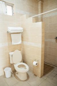a bathroom with a toilet and a shower at Hotel La Joya Del Lago in Ajijic