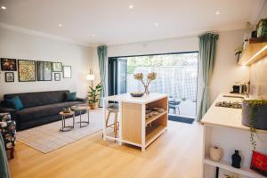 a living room with a couch and a table at Suite 273 - Luxe Solar Suite - Heated Pool in Cape Town