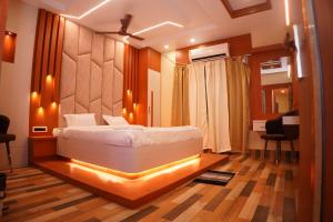 a bedroom with a bed with lights on it at Hotel ganga sarovar Inn in Deoghar
