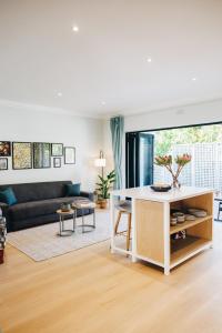 a living room with a table and a couch at Suite 273 - Luxe Solar Suite - Heated Pool in Cape Town