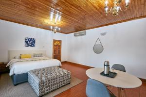 a bedroom with a bed and a table at 4bnb in Gaborone