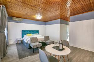 a bedroom with a bed and a table and chairs at 4bnb in Gaborone