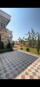 a checkered tile driveway in front of a house at Rj Executive Apartments in Dodoma