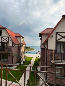 a view of the beach from a house at Семейные номера с ванной, кухней в Яхт Виллидж Чолпон-Ата in Cholpon-Ata