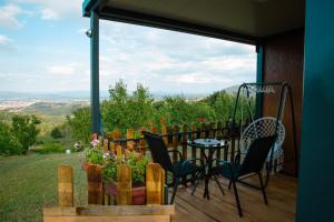 a balcony with a table and chairs and a view at Casa Dunja Čačak in Čačak