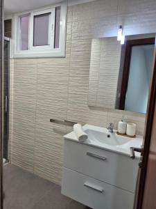 a bathroom with a sink and a mirror at Casa Beleví - Laxe, sea and rest in Laxe +43 photos