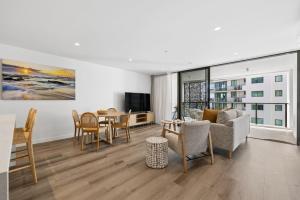 a living room with a couch and a table at Sakara at Marochydore in Maroochydore